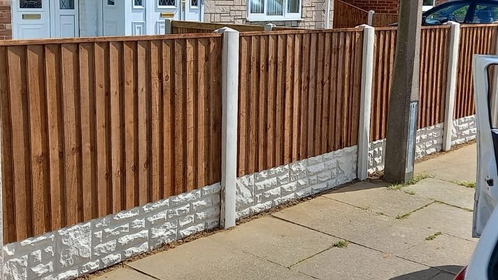 Street-side close-board fencing over decorative gravel boards